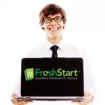 Smiling young man holding opened laptop isolated on white background